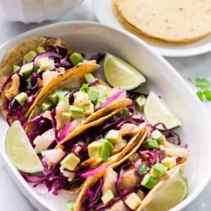 Overhead view of a platter containing Grilled Fish Tacos