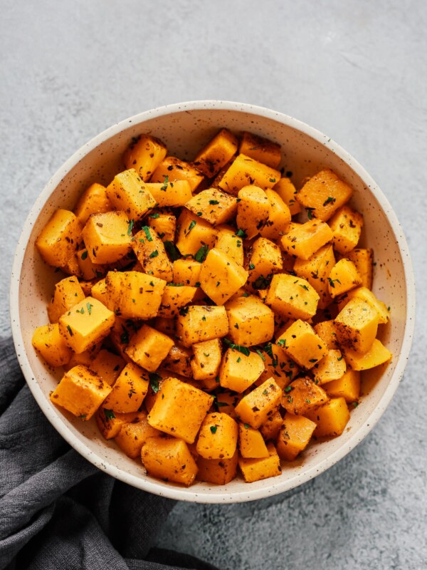 Overhead photo of a white bowl of roasted butternut squash.