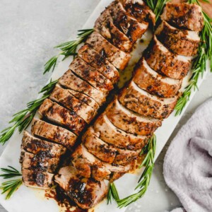 overhead view of balsamic Roast Pork Tenderloin on a marble board