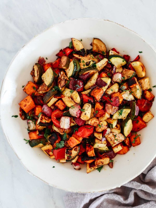 An overhead photo of a white bowl with balsamic roasted veggies inside.