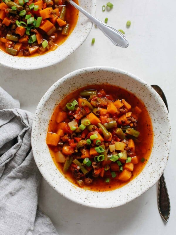 overhead view of a white bowl containing ground beef vegetable soup
