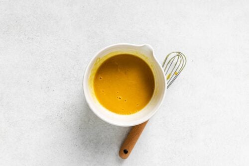 Dijon sauce inside of a white bowl