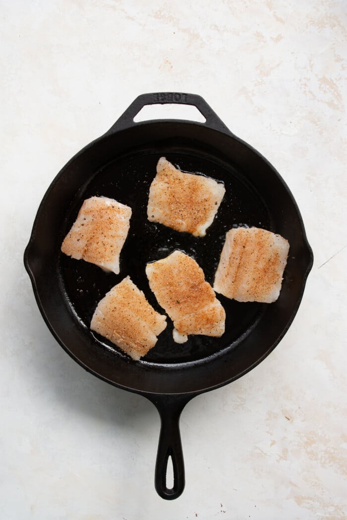 seasoned raw cod in a skillet