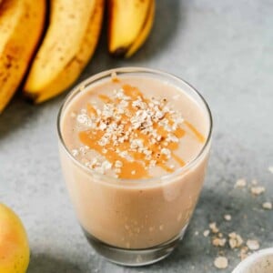cup of apple smoothie with oats sprinkled on top