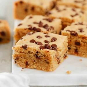Close up of healthier chocolate chip cookie bars on a marble serving board.