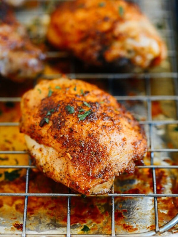 A close up of a chicken thighs on a rack