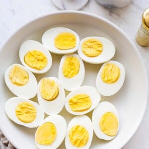 a plate with hard boiled eggs cut in half
