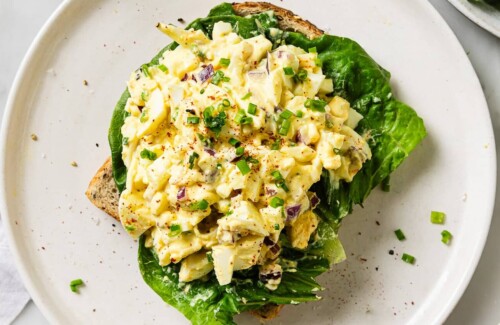 egg salad on top of some bread sliced.
