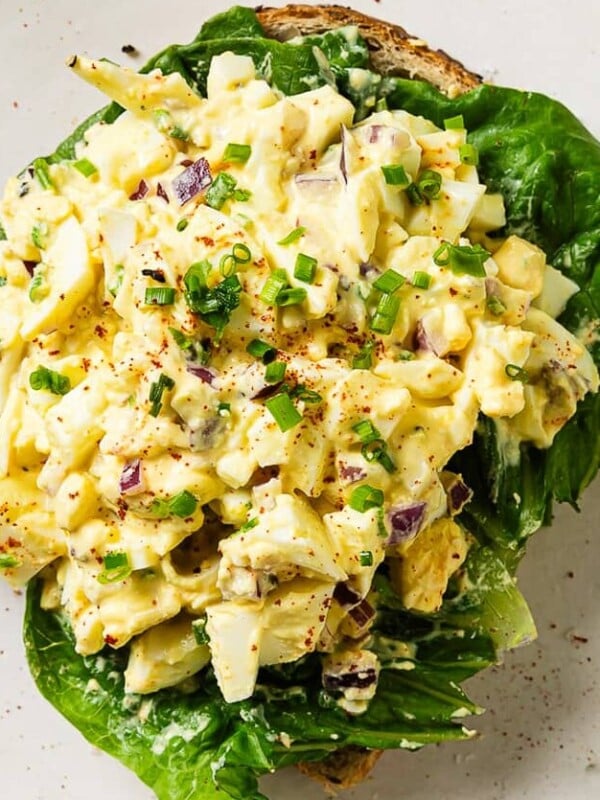 egg salad on top of some bread sliced.