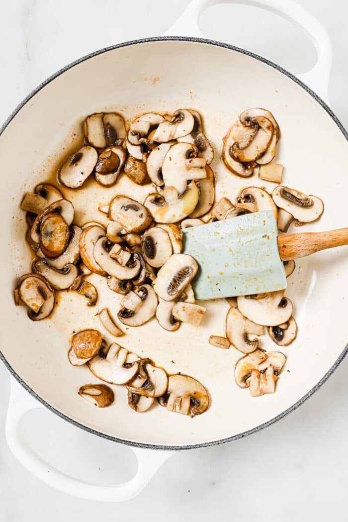 sauteed mushroom in a white skillet