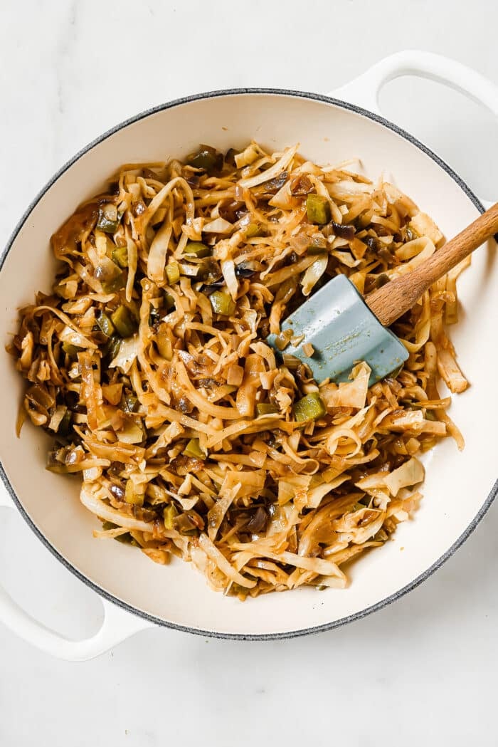 sautéed cabbage in a white skillet.