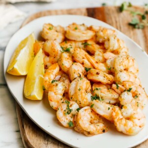 overhead view of a white plate containing cooked shrimp