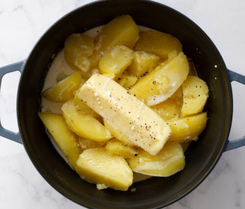 Cooked potatoes with butter and cream in a pot.