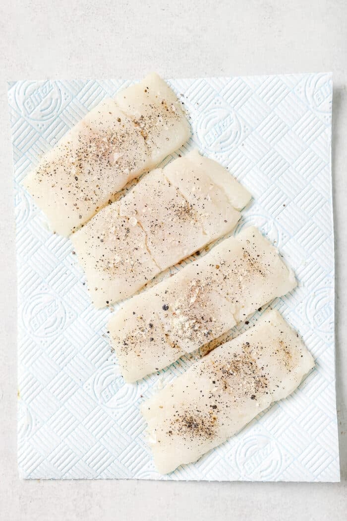 Raw Haddock fillets on a countertop