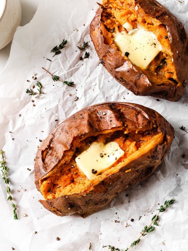 overhead view of Air Fryer Baked Sweet Potato on a countertop and parchment paper.