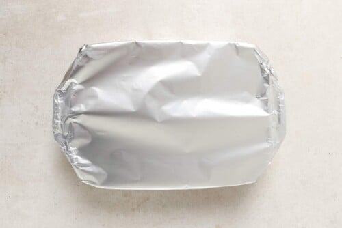 white casserole covered with foil