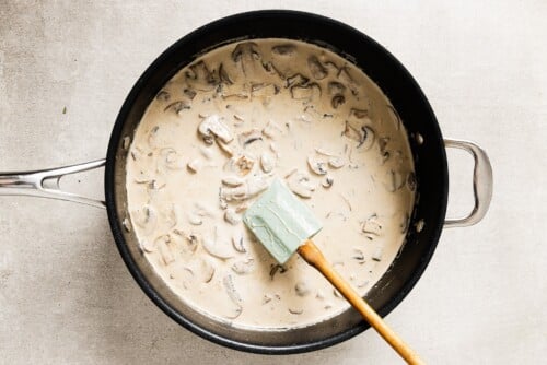 creamy mushroom sauce and chicken breast in a skillet