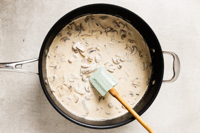 creamy mushroom sauce and chicken breast in a skillet
