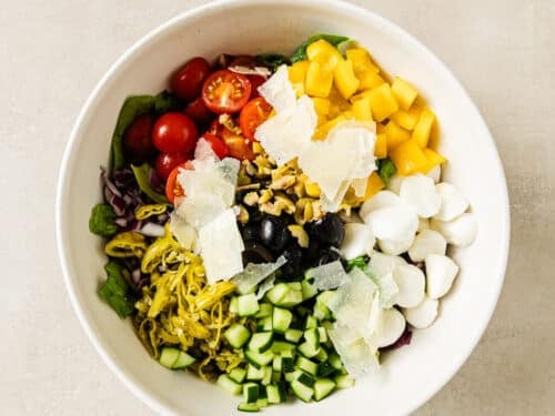 ingredients for Italian salad in a white bowl