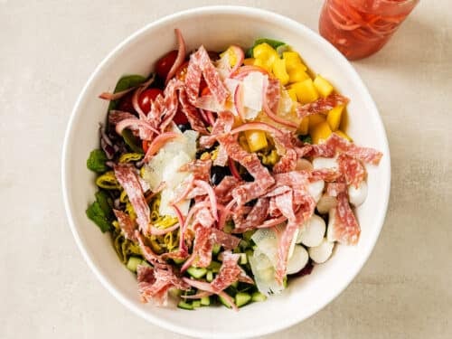 ingredients for Italian salad in a white bowl