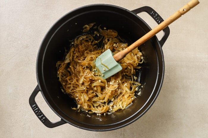 sauteed onions in a black Dutch oven pot.