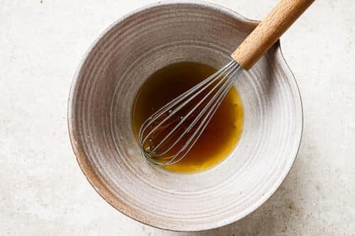 Bowl filled with melted butter and maple syrup, ready to mix.