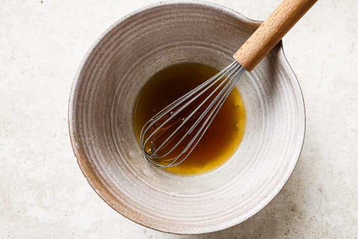 Bowl filled with melted butter and maple syrup, ready to mix.