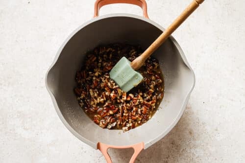saucepan with melted butter, maple syrup, sugar, vanilla, salt, chopped pecan and milk.