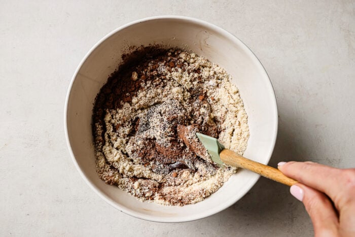 Rich pecan pie brownie batter in a white mixing bowl.