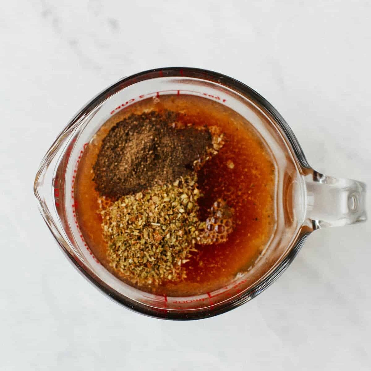 chicken broth, seasonings and cup of glass.