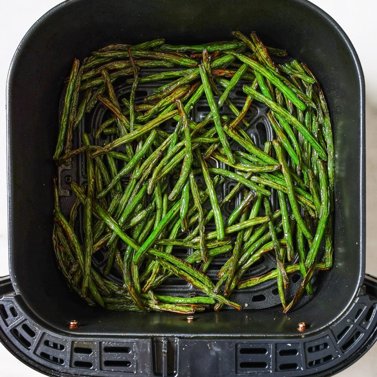 Green Beans in an Air Fryer basket